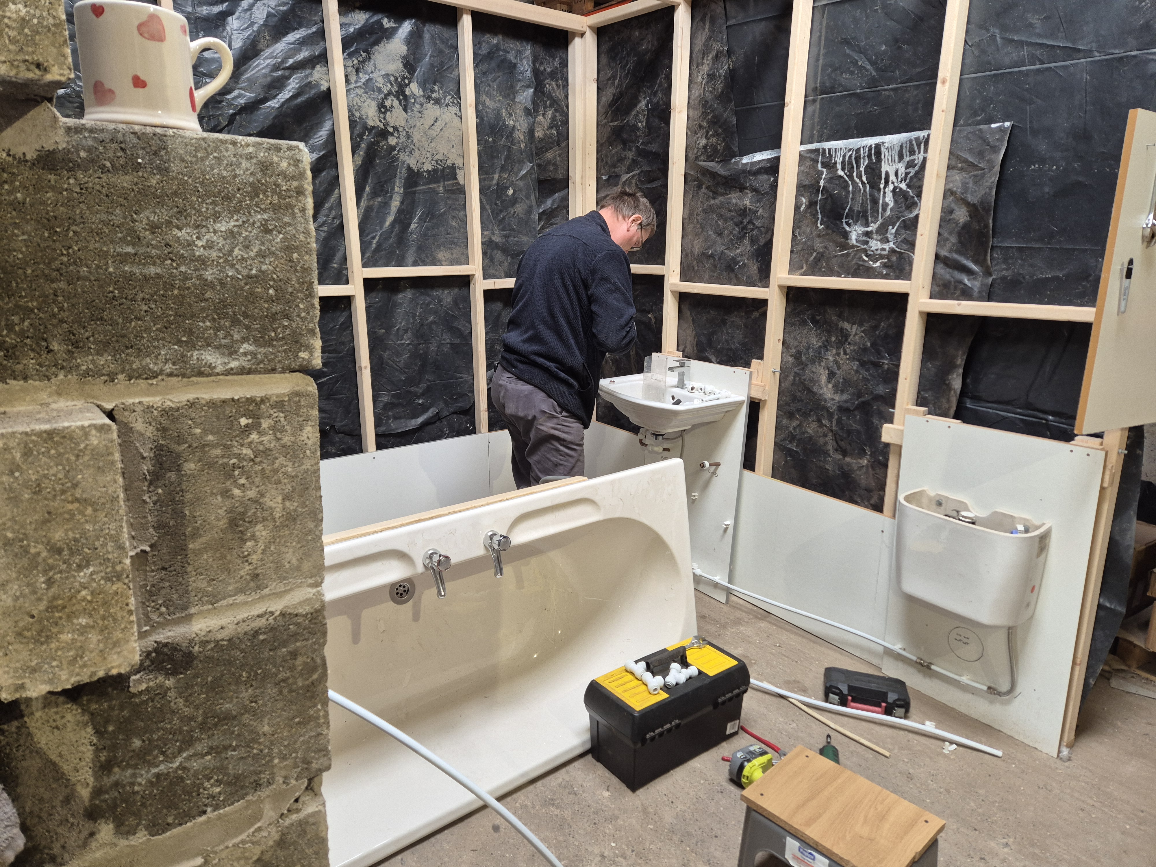 Learner working inside a Plumbing training mock-up room